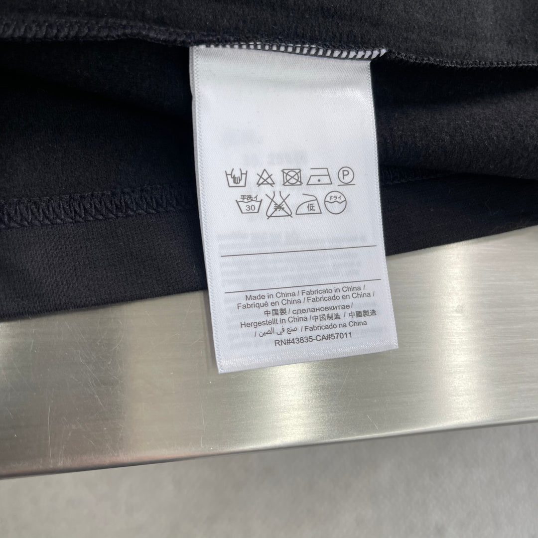 Dior clothing care label inside with washing symbols and size info