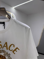 White crew-neck T-shirt shoulder detail with gold VERSACE lettering