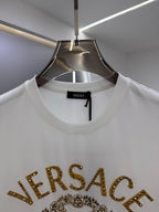 White crew-neck T-shirt with VERSACE text on chest, close-up