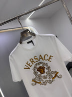 White crew-neck T-shirt with gold VERSACE logo and lion medallion graphic