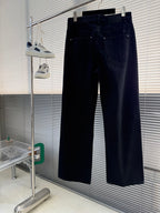 Dark denim pants with front pockets and button closure, wide straight leg