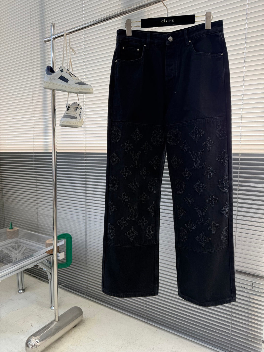 Dark denim pants with tonal monogram pattern, belt loops, and front pockets