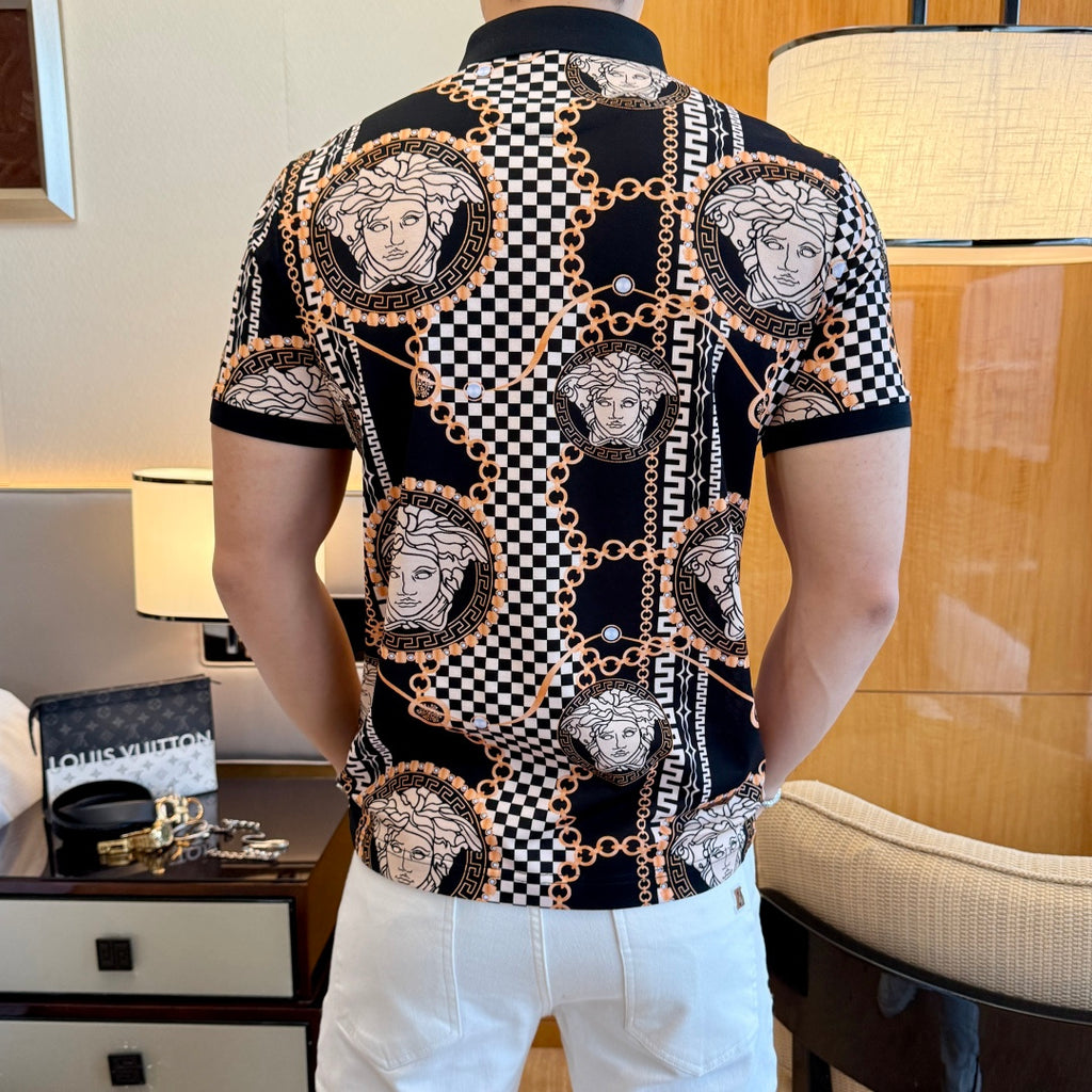 Black short-sleeve polo shirt with scattered Medusa portraits, checkered panels, and gold chain print.