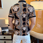 Black short-sleeve polo shirt with scattered Medusa portraits, checkered panels, and gold chain print.