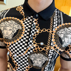 Black polo shirt chest close-up with gold chain links, checkered stripe, and Medusa medallions.