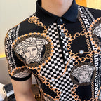 Black polo shirt close-up: contrast collar, Medusa medallion, checkered panel, and gold chain print.