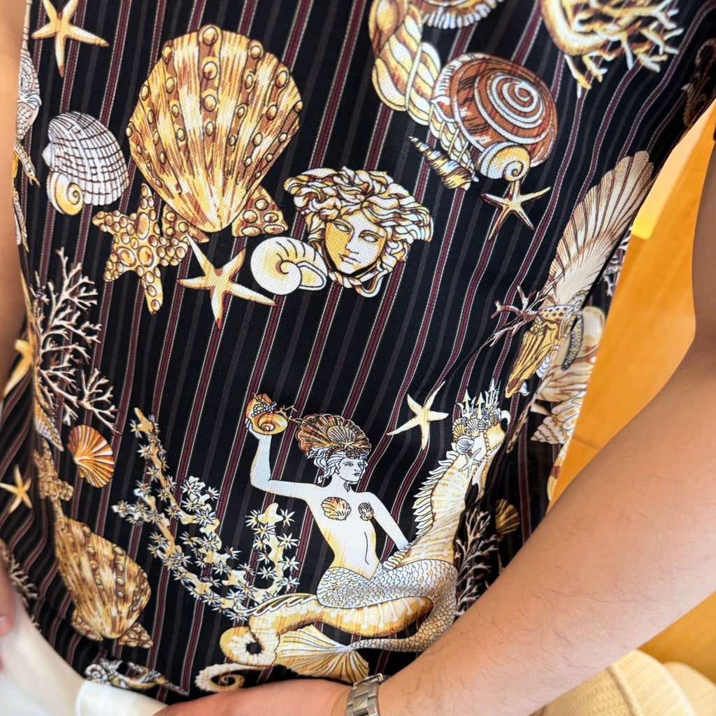 Short-sleeve polo shirt print detail with mermaid figures and seashell motifs