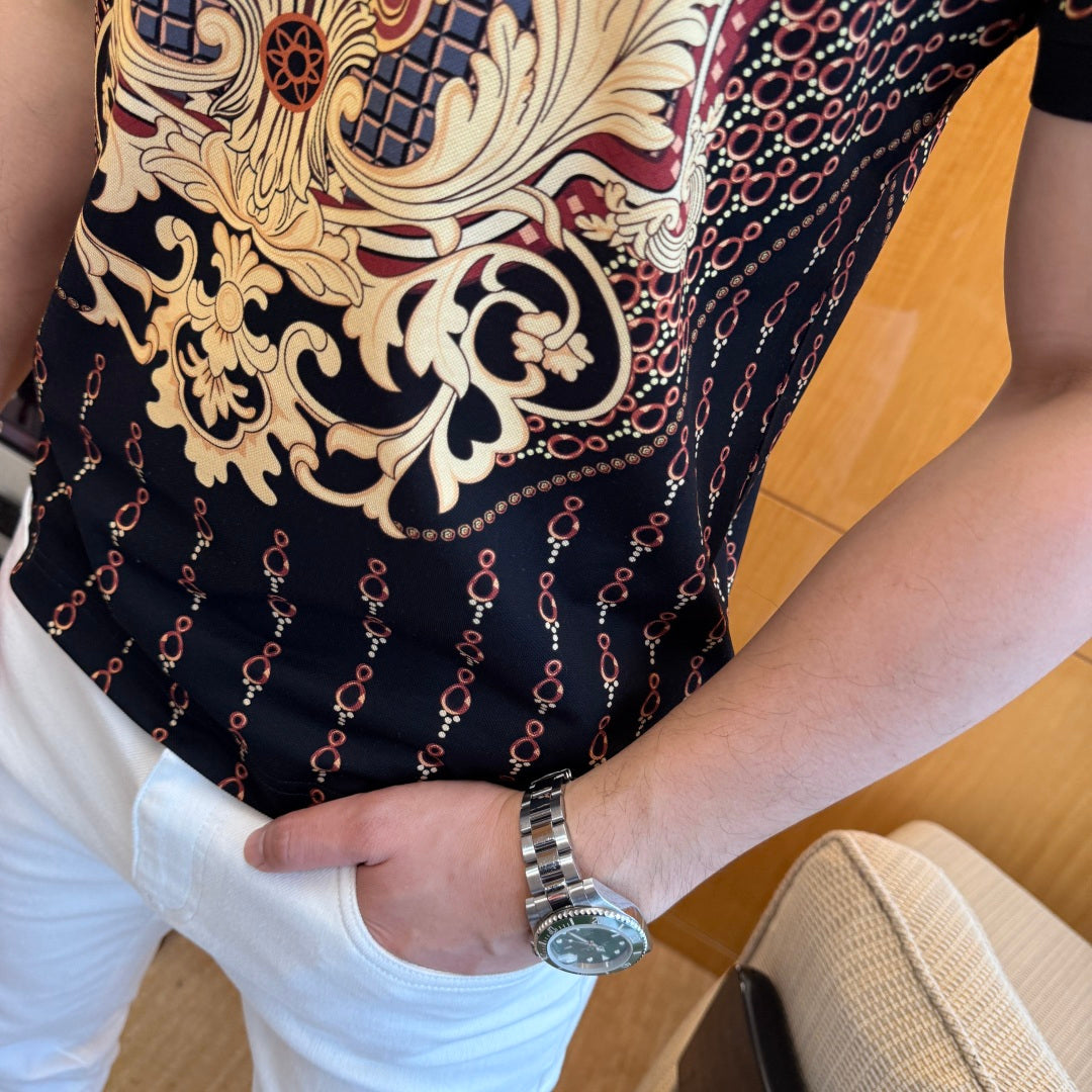 Polo shirt midsection close-up: gold scrolls and red chain pattern on dark fabric