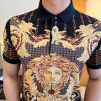 Polo shirt close-up: gold baroque artwork across chest on dark fabric, button collar