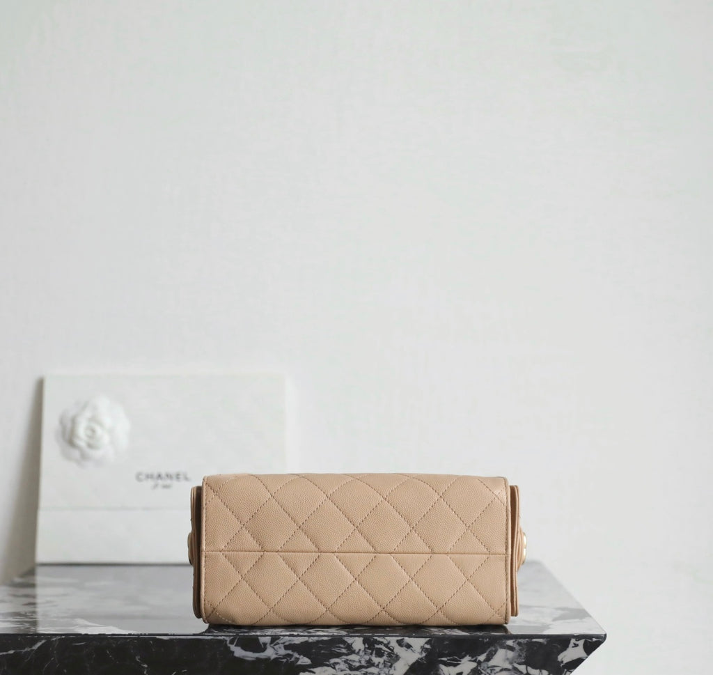 Chanel beige quilted flap bag with gold-tone hardware and chain shoulder strap.
