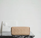 Chanel beige quilted flap bag with gold-tone hardware and chain shoulder strap.