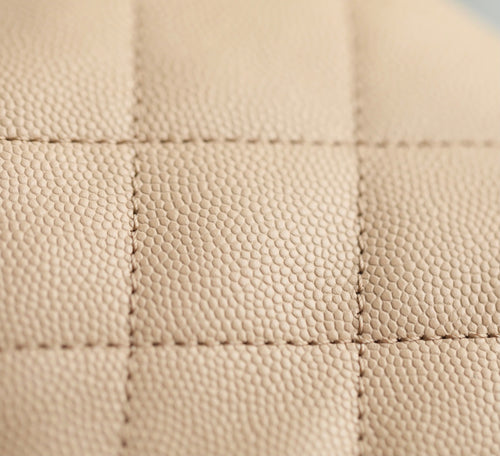 Chanel beige quilted leather panel with diamond stitching detail.