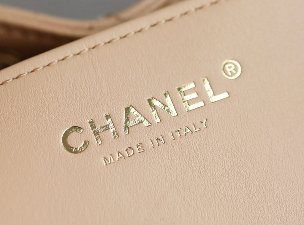 Chanel logo on beige leather, with 'MADE IN ITALY' text below.