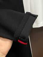 Black pants hem and interior waistband trim with red accent stripe