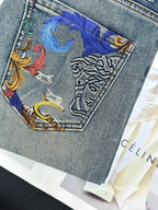 Light-wash denim jeans with multicolor ornamental print patch on pocket