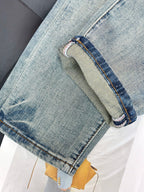 Denim jeans hem with stitched cuff and side pocket seam detail
