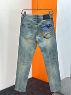 Light-wash denim jeans with back pocket embroidery and front fly detail