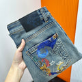 Versace denim jeans with dark patch logo and colorful graphic back pocket