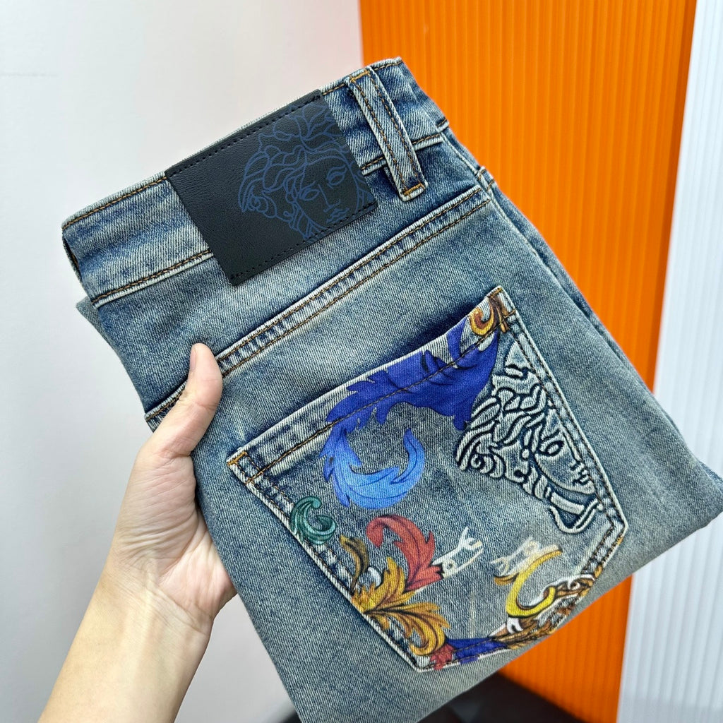 Versace light-wash denim jeans with embroidered front pocket and black waistband label