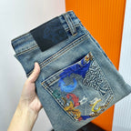 Versace light-wash denim jeans with embroidered front pocket and black waistband label