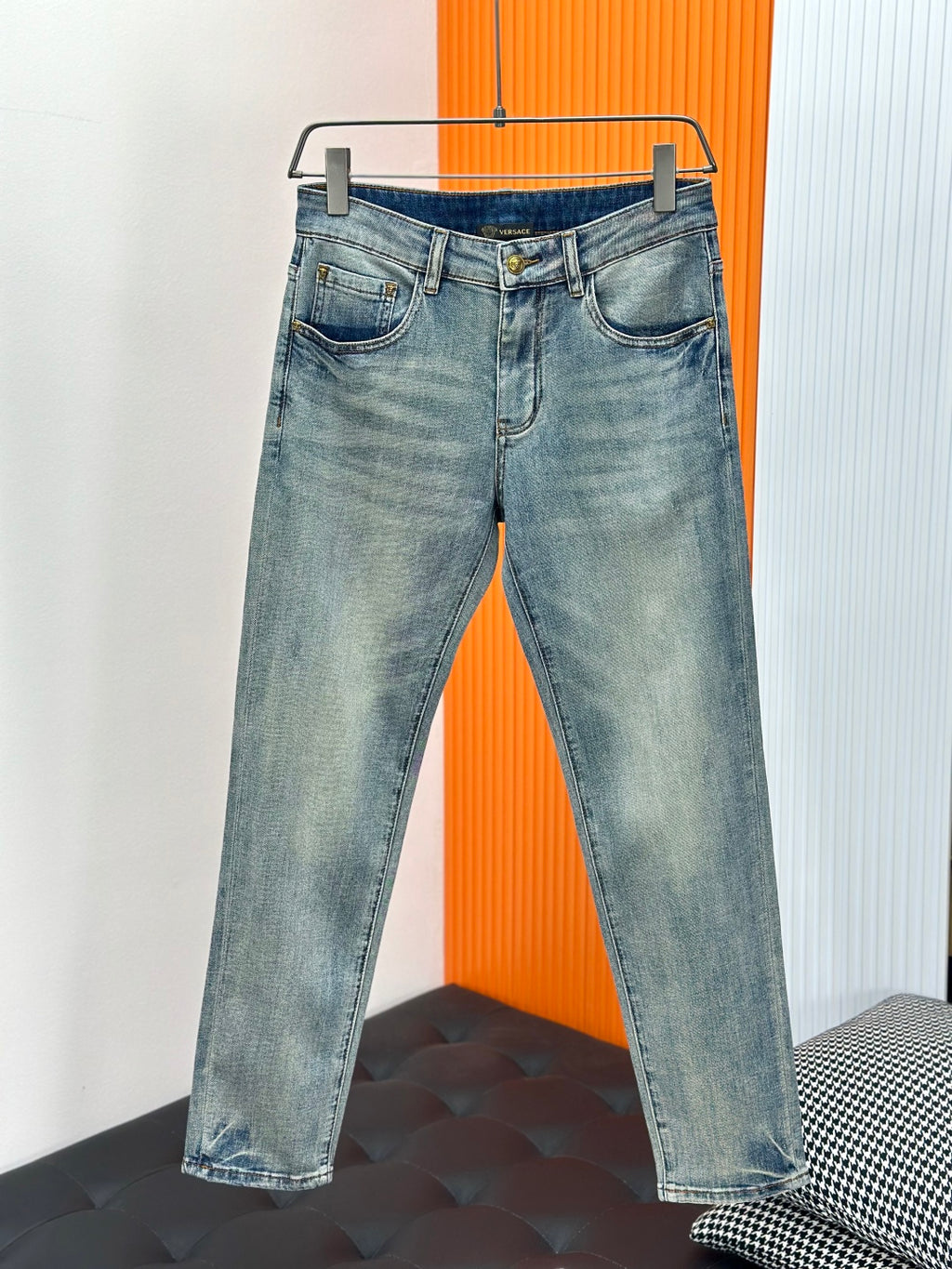 Light-wash denim jeans with button closure, belt loops, and two front pockets