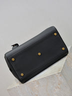 Black pebbled leather zip wallet with gold-tone studs and side hardware