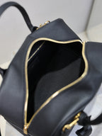 Black handbag interior with gold-trimmed zipper opening