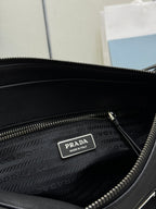 Prada handbag interior close-up: dark lining, zip pocket, metal logo tag.