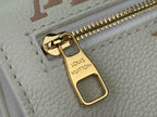Louis Vuitton bag close-up of gold zipper pull and Louis Vuitton Paris label