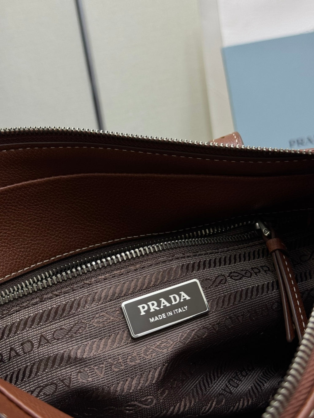 Brown Prada interior zip pouch with Prada "Made in Italy" label