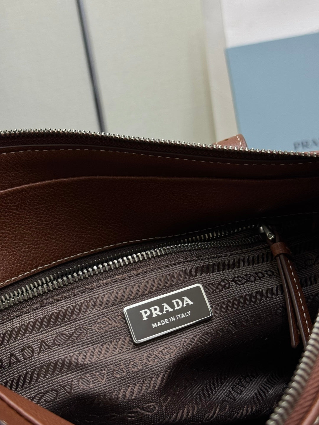Brown Prada interior zip pouch with Prada "Made in Italy" label