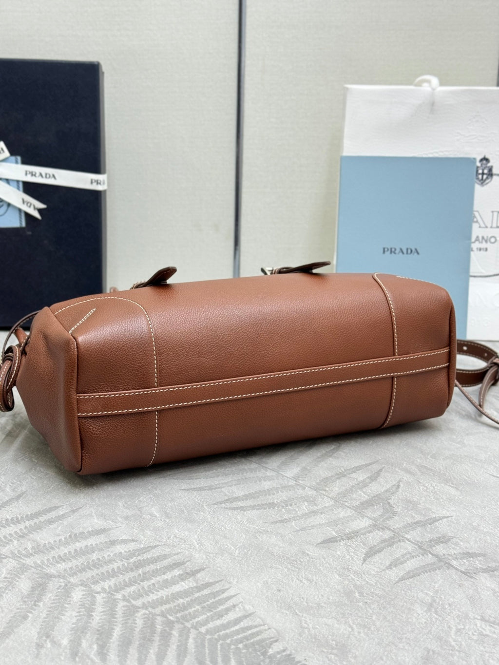 Brown Prada duffel bag with zip top and detachable crossbody strap