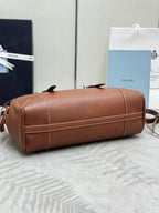 Brown Prada duffel bag with zip top and detachable crossbody strap