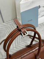 Brown Prada leather strap detail with metal buckle and stitched edge
