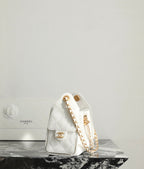 Chanel white quilted handbag with gold logo medallion and chain shoulder strap