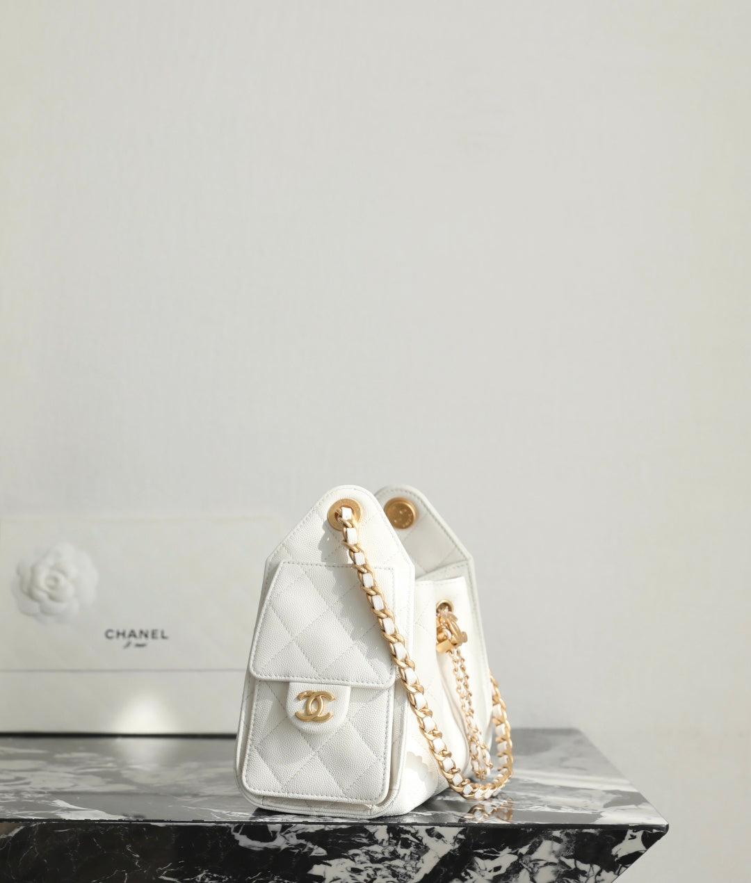 Chanel white quilted handbag with gold logo medallion and chain shoulder strap