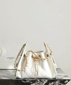 Chanel white quilted handbag with gold chain straps and curved top handle