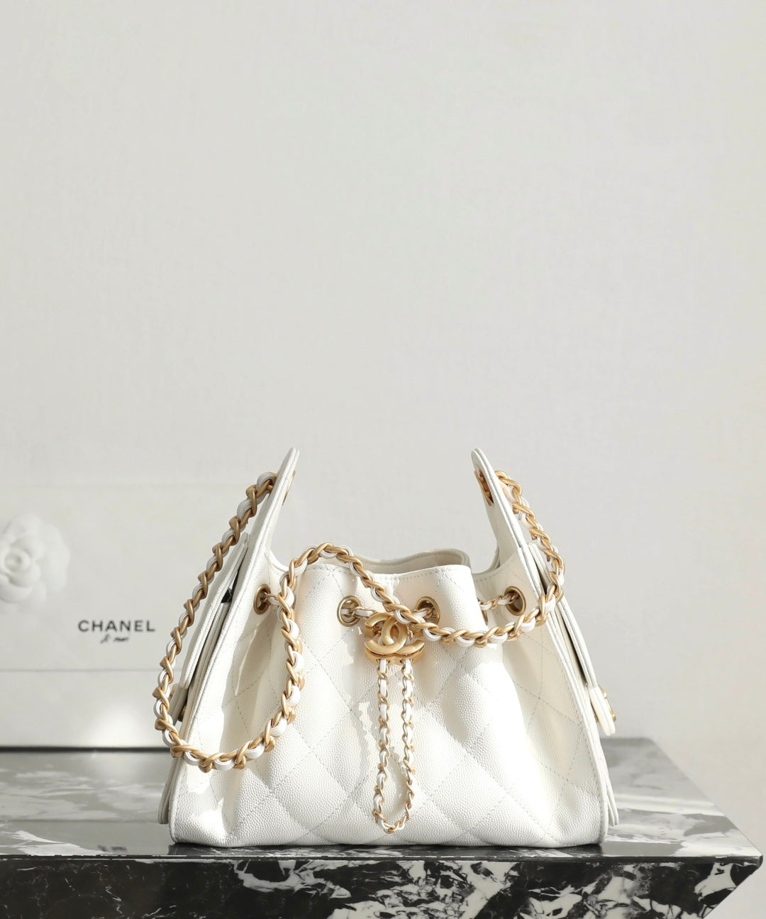 Chanel white quilted handbag with gold chain straps and curved top handle