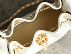 Chanel handbag interior with gold chain and clasp hardware, white lining