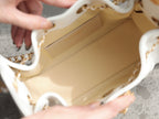 Chanel handbag interior open view with stitched pocket and gold chain edge