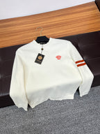 Off-white Versace crewneck sweater with red logo and striped sleeve on hanger.