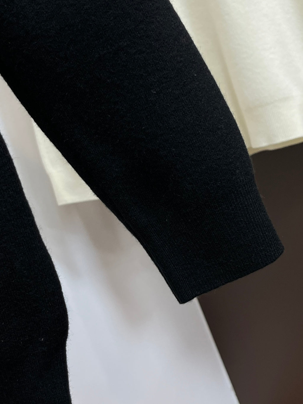 Black knit sweater sleeve with ribbed cuff