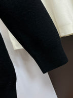 Black knit sweater sleeve with ribbed cuff