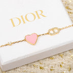 Gold-tone bracelet with pink heart charm and rhinestone letter accents