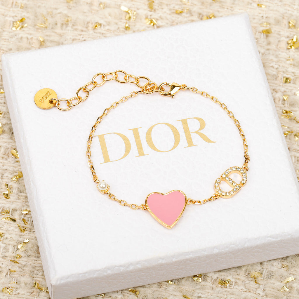 Dior gold-tone heart charm bracelet with pink enamel and rhinestone letter charms
