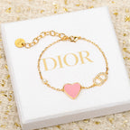 Dior gold-tone heart charm bracelet with pink enamel and rhinestone letter charms