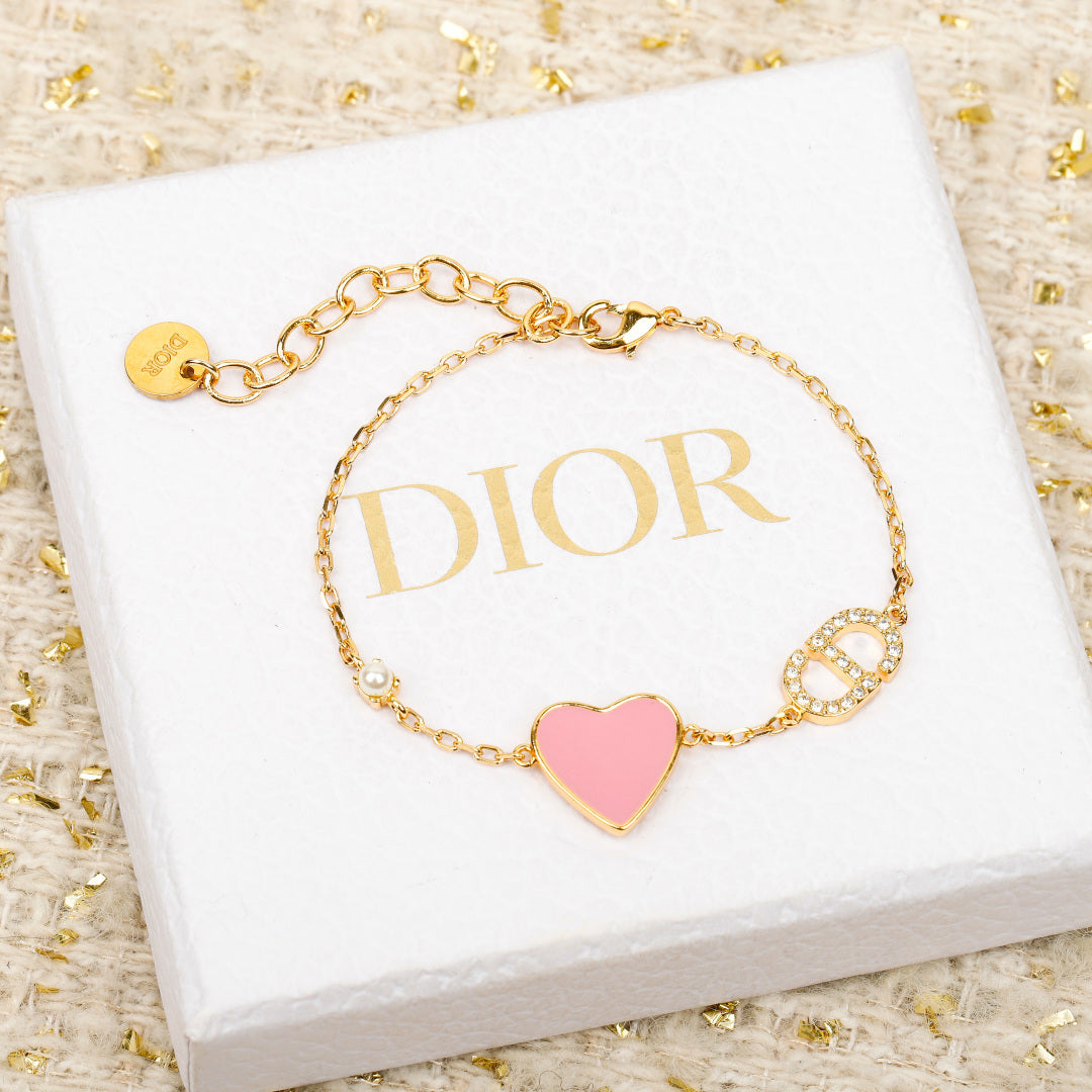 Dior gold-tone heart charm bracelet with pink enamel and rhinestone letter charms