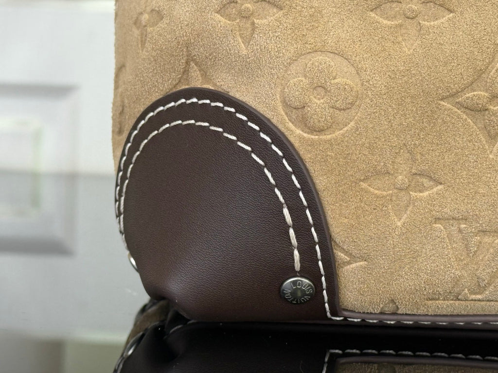 Louis Vuitton monogram bag corner with dark leather trim and white contrast stitching