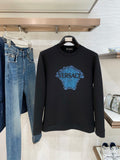 Versace black sweatshirt with blue Medusa-style logo graphic on the chest