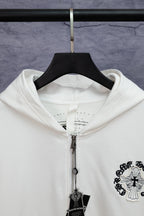 White long-sleeve zip hoodie close-up with hood, zipper, and hanging cross charm